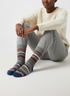 Frost Loom socks flat lay showing cool grey, navy, and orange heritage wool-blend stripe knit