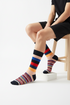 Varsity Block crew socks on model showing navy, peach, blue, red, and gold block stripe pattern